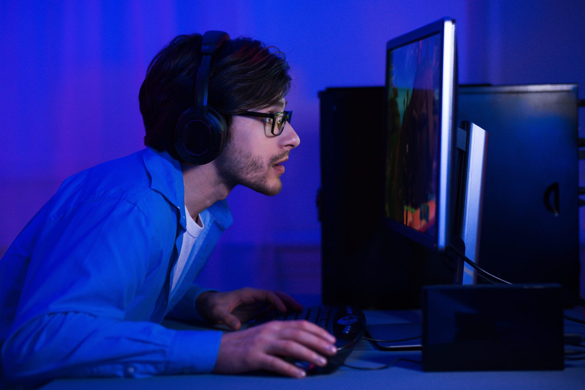 Bad Habits May Include Procrastination. Man Playing Video Games Instead of Working. Positive Habits Can Help Productivity.