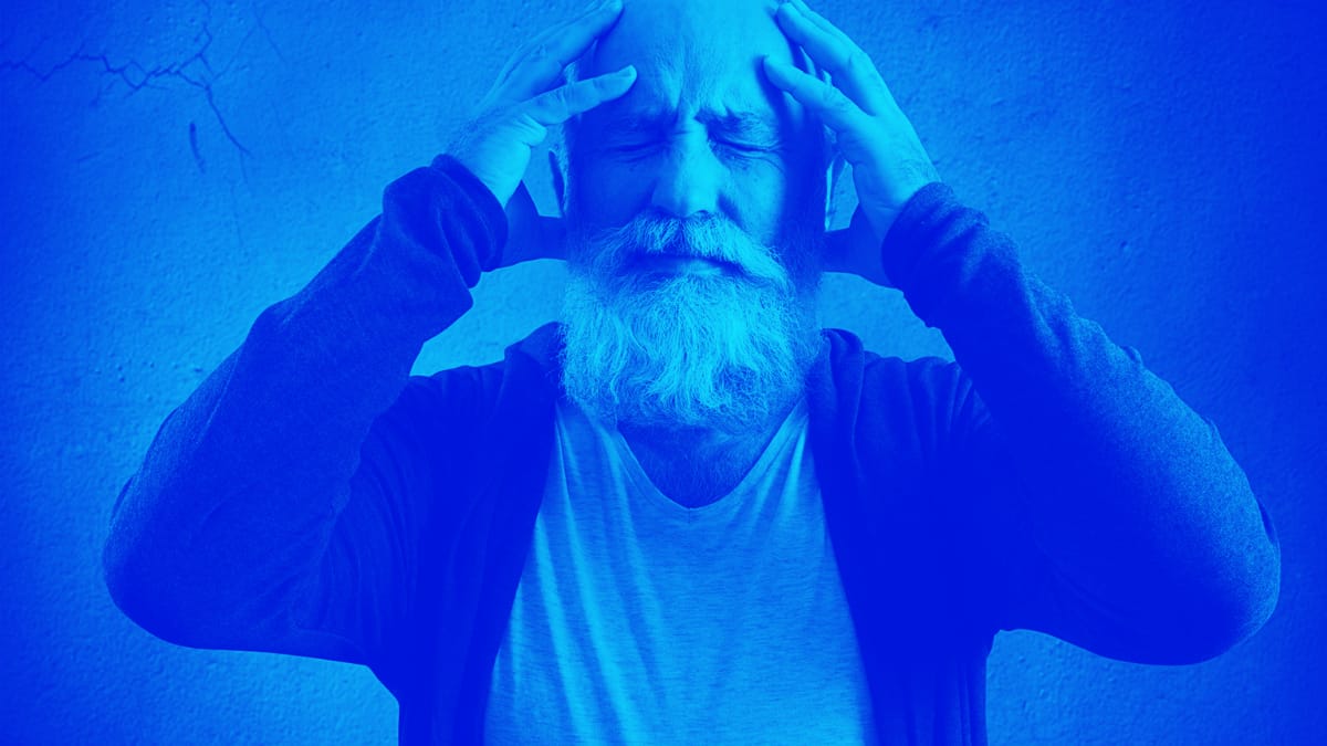 Man Holding Head Experiencing Pain.