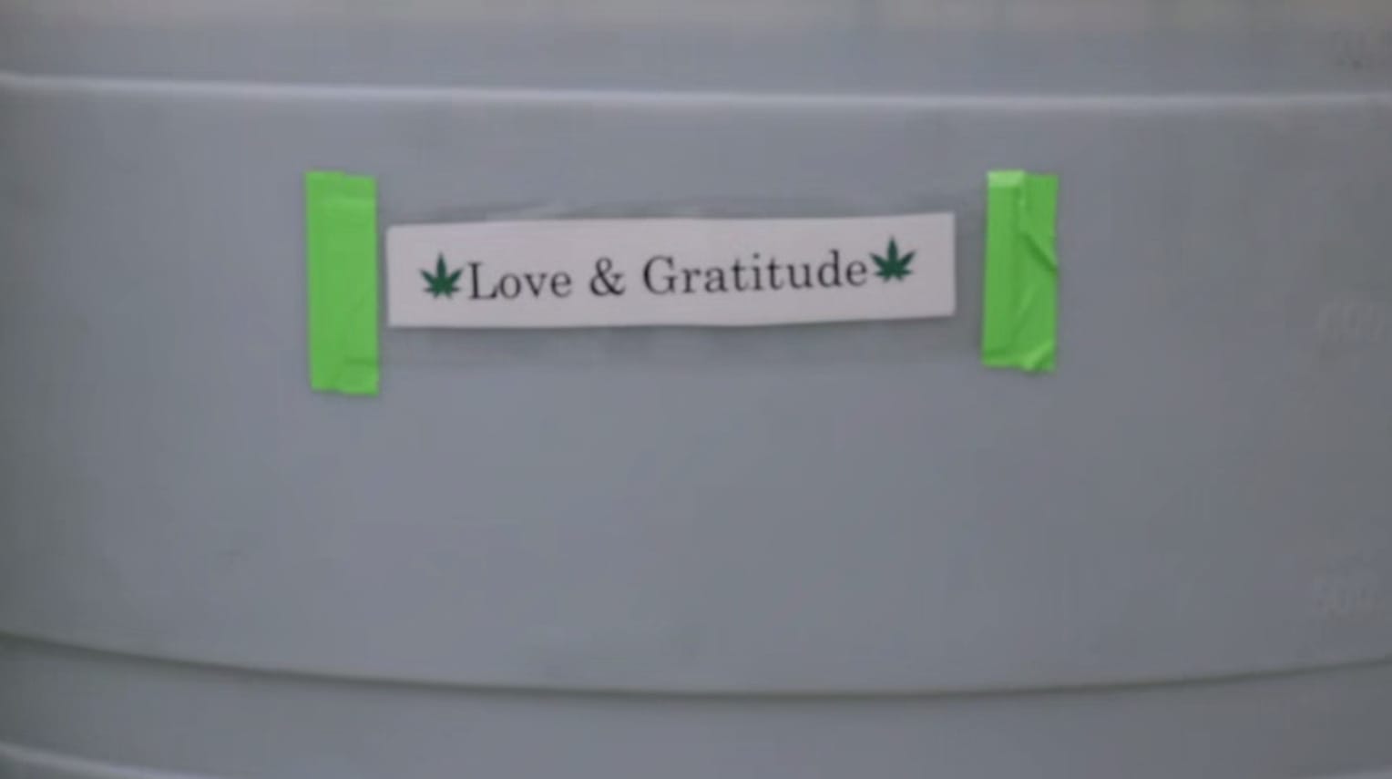 Gibbys Garden - Love and Gratitude- This is where the harvested rainwater goes it has a label reading love and gratitude.
